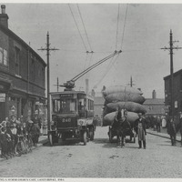 2024.56.8: Trolley bus overtaking a horse-drawn cart, Laisterdyke, 1914. Image credit: Saltaire Collection